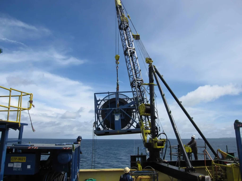Offshore heavy lifting with Thunder Crane services showing yellow crane equipment and workers on sea platform