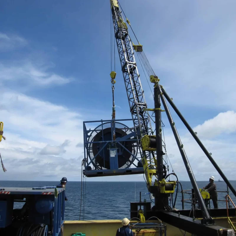 Offshore heavy lifting with Thunder Crane services showing yellow crane equipment and workers on sea platform