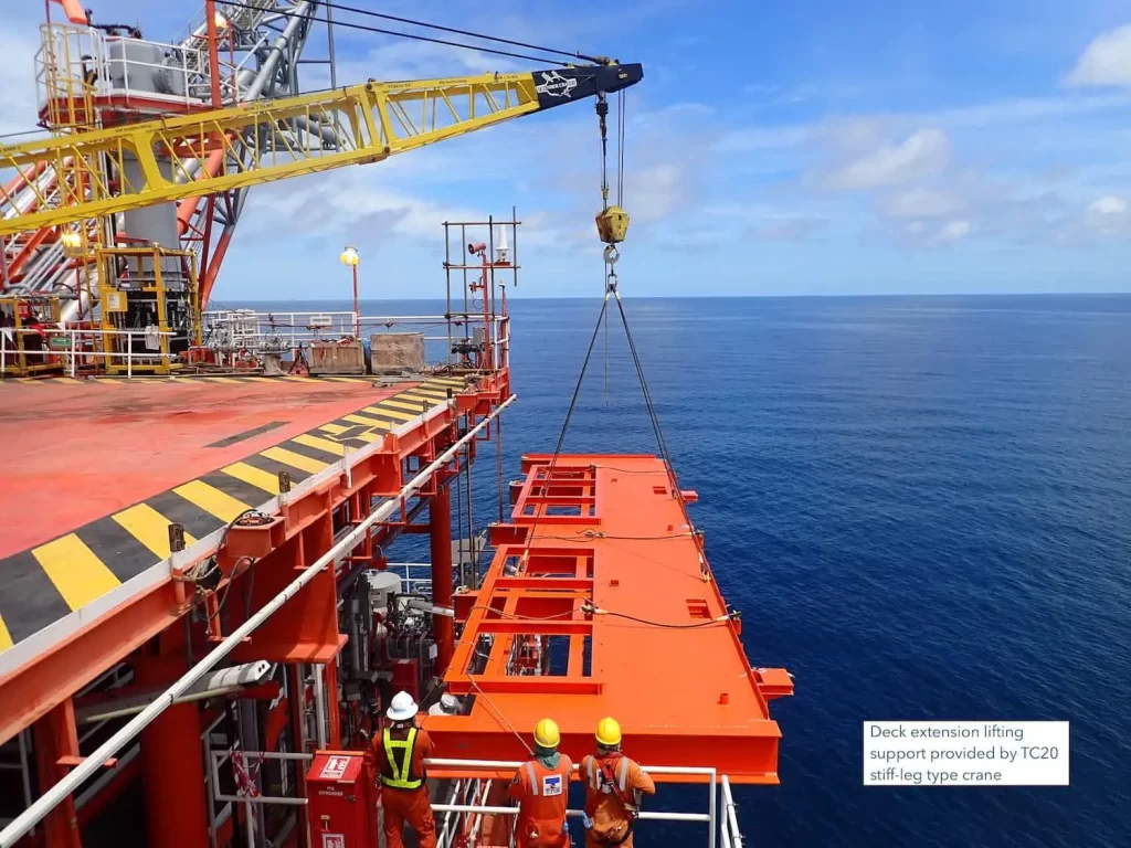 Thunder Crane TC20 stiff-leg equipment lifting red deck extension modules during offshore installation