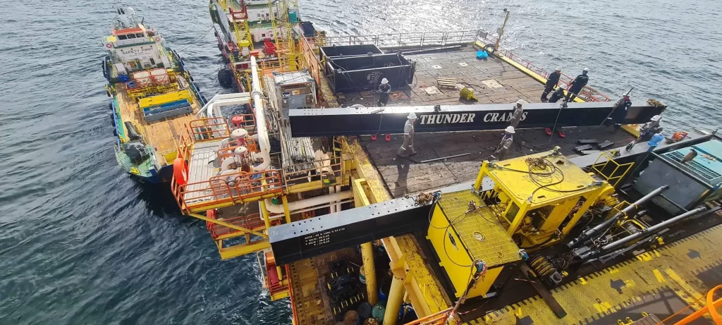 Offshore CTU operations with Thunder Crane vessel and yellow lifting equipment on ocean platform